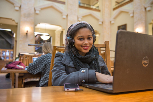 Student working on laptop in Carnegie Library displayed in a new window