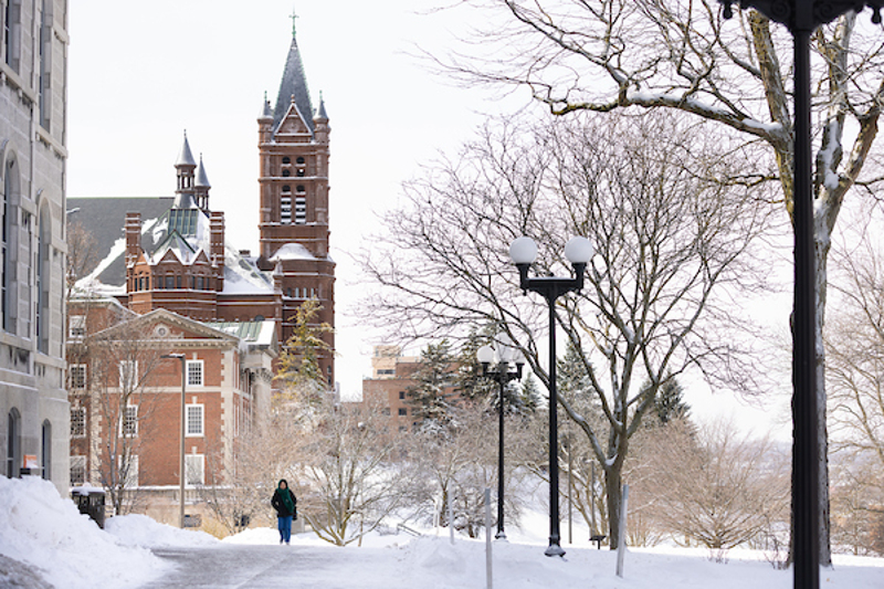 Student walking across campus in the winter displayed in a new window