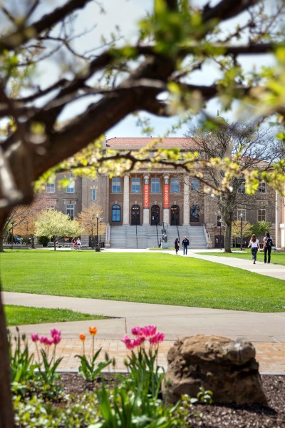 Students walking across campus in front of Carnegie Library displayed in a new window