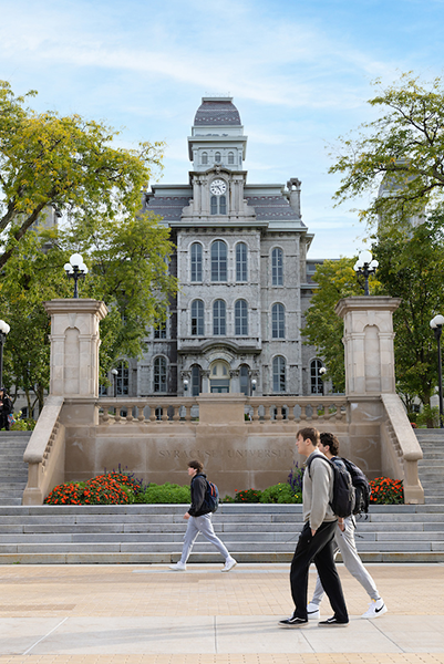 Students walking across campus in front of The Hall of Languages displayed in a new window