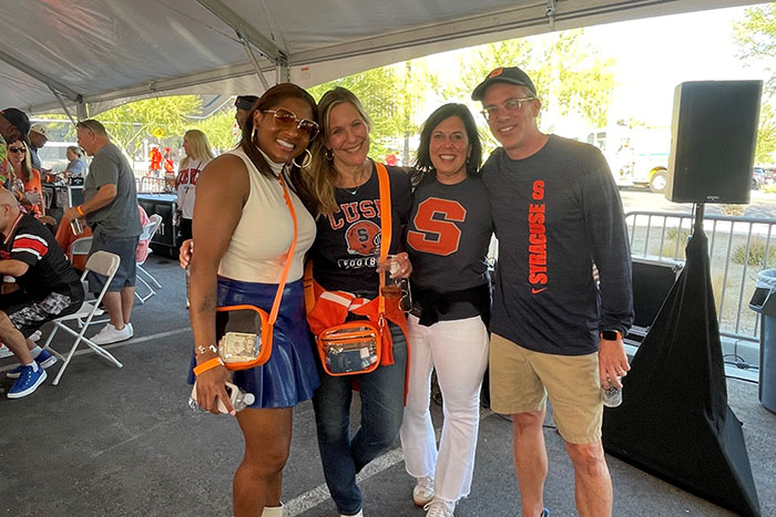 Alumni pose with Teara Brown, wife of head football coach Fran Brown. displayed in a new window